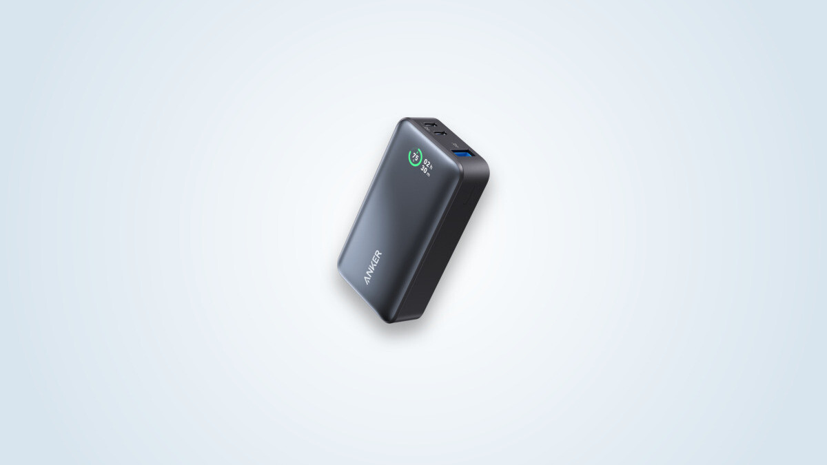 Anker 533 PowerCore power bank at a three-quarter angle, colour screen lit showing 75% and a remaining time, with its two USB-C ports and USB-A port visible