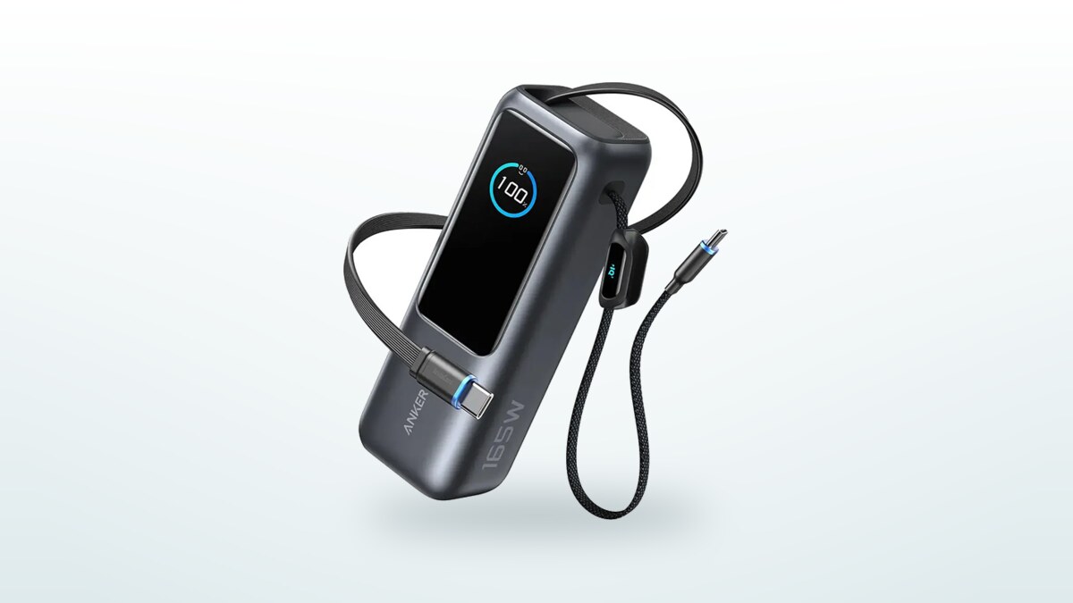 Anker A1695 power bank seen at a three-quarter angle, display lit at 100 %, retractable USB-C cable and built-in cable extended on either side of the case