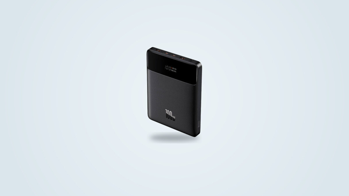 Baseus Blade 100W power bank shown at an angle, display lit up showing charge percentage and wattage, four ports visible on the edge