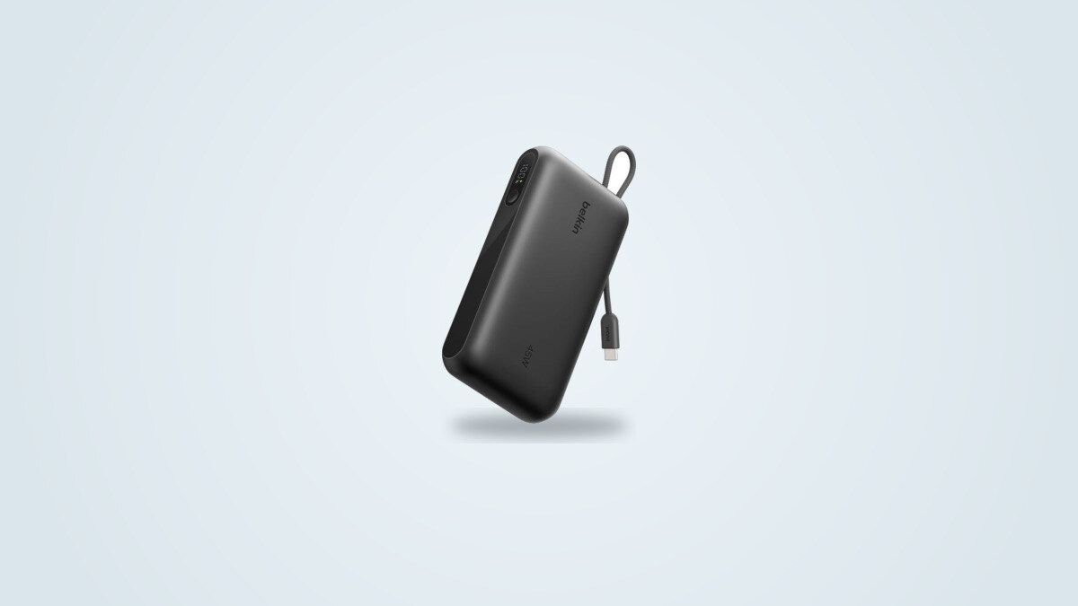 Belkin UltraCharge 20K power bank at a three-quarter angle, built-in USB-C cable unwound, digital display showing the charge percentage