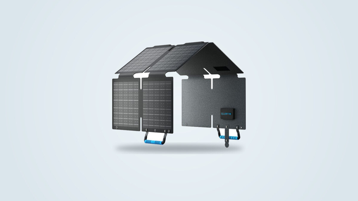 Bluetti PV60 60W foldable solar panel deployed at an angle against a light background, its monocrystalline panels raised, carry handle and BLUETTI case visible