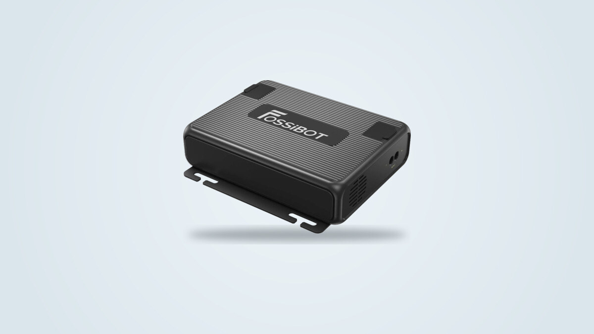 Fossibot FAC580 alternator charger seen from a three-quarter angle, ribbed black casing with the Fossibot logo and input cable port visible