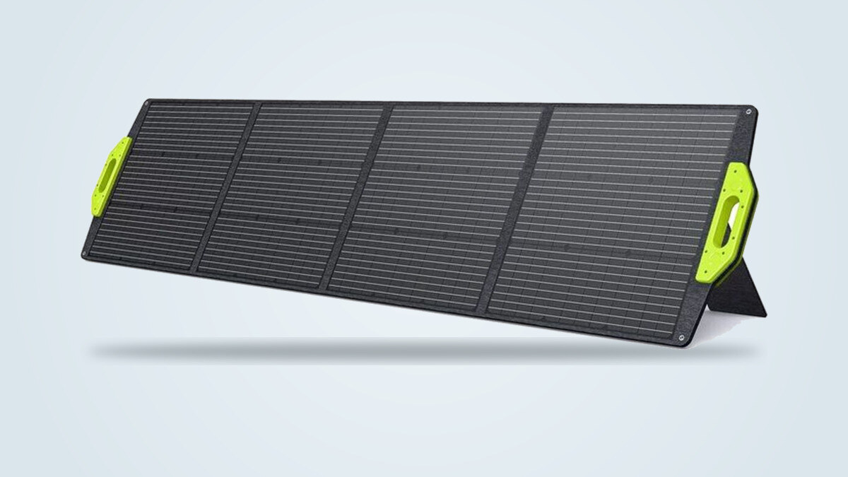 Fossibot SP200 foldable solar panel deployed at an angle, its four monocrystalline panels and bright green end handles visible