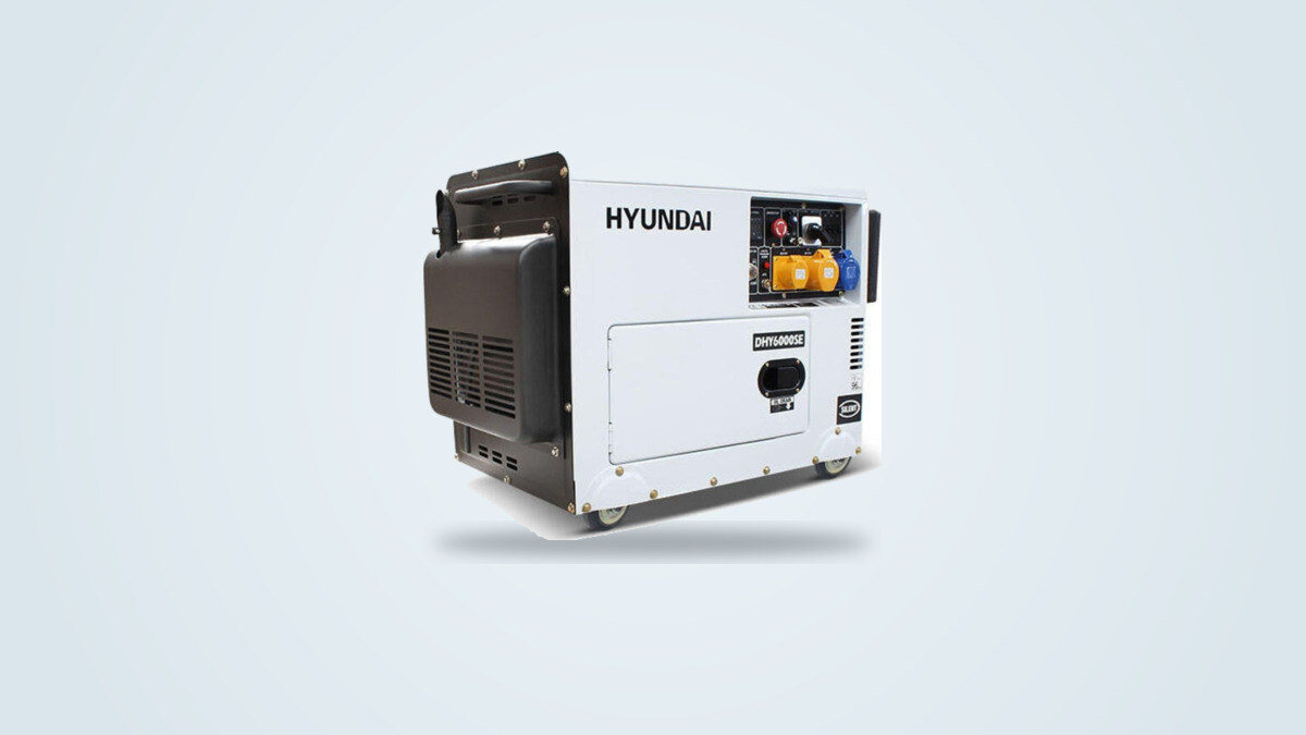 White and black Hyundai DHY6000SE diesel generator on a wheeled frame, seen from a three-quarter angle, 230V outlet panel and digital display visible