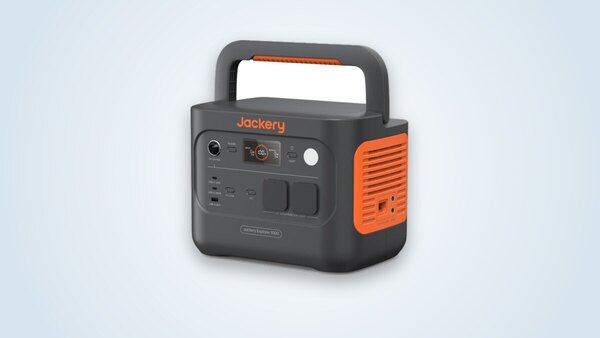 Jackery Explorer 1000 v2 portable power station at three-quarter angle, handle raised, screen lit and 230 V sockets visible