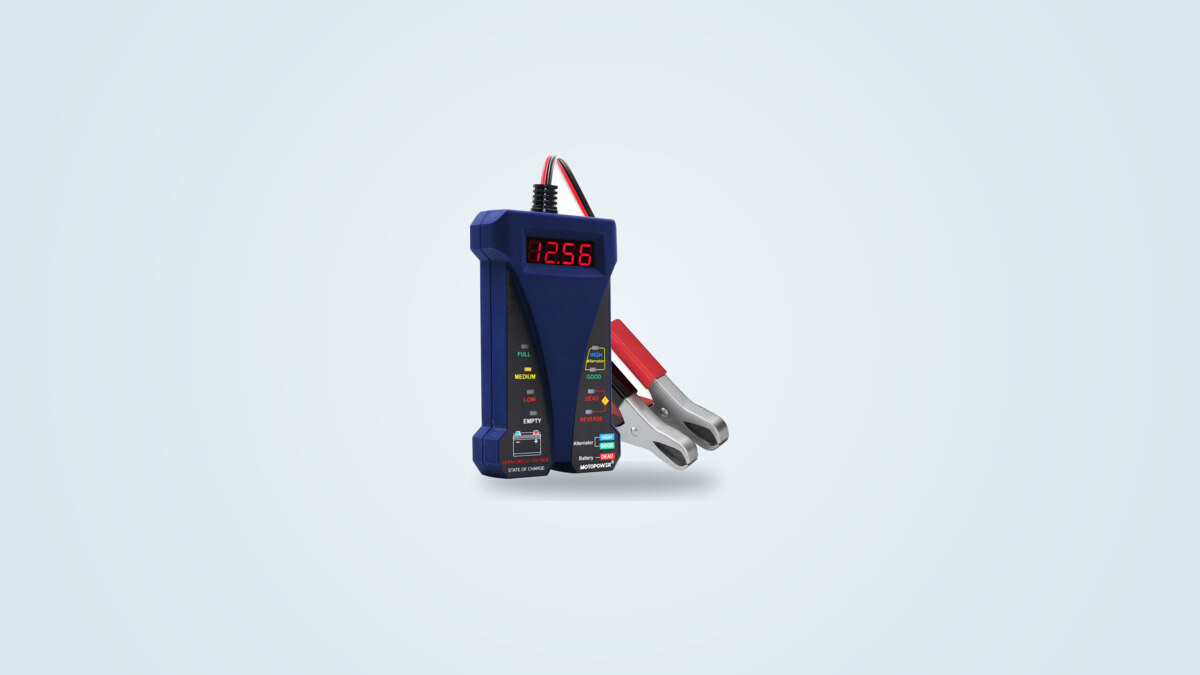 Motopower MP0514B battery tester seen at an angle, LCD screen showing a voltage reading, red and black clamps and eight coloured LEDs visible