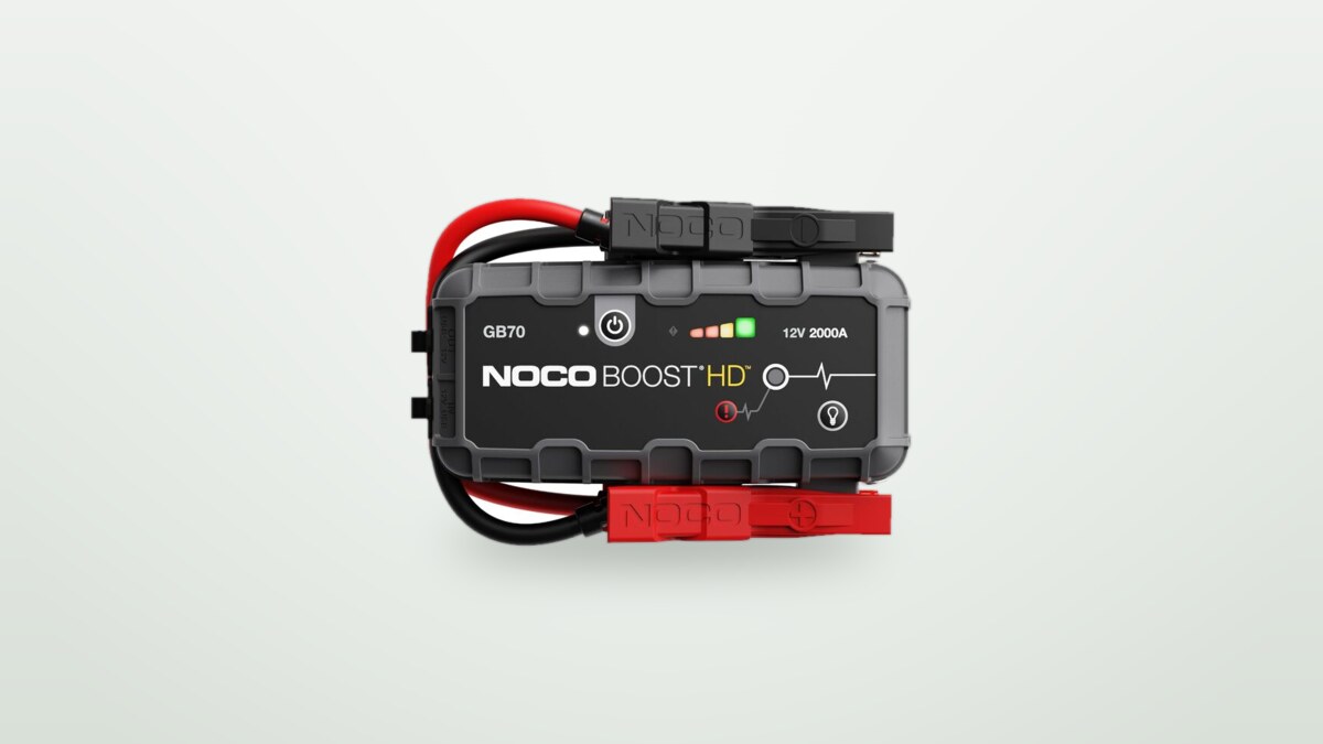 Noco GB70 jump starter with its clamps on a light background