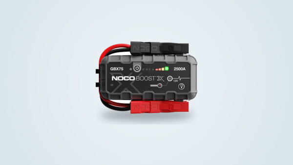 NOCO GBX75 Boost X jump starter seen from the front, integrated red and black clamps, control screen and charge indicator visible