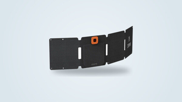 Xtorm SolarBooster 28W foldable solar panel unfolded across four panels, LCD screen and X 28W logo panel visible