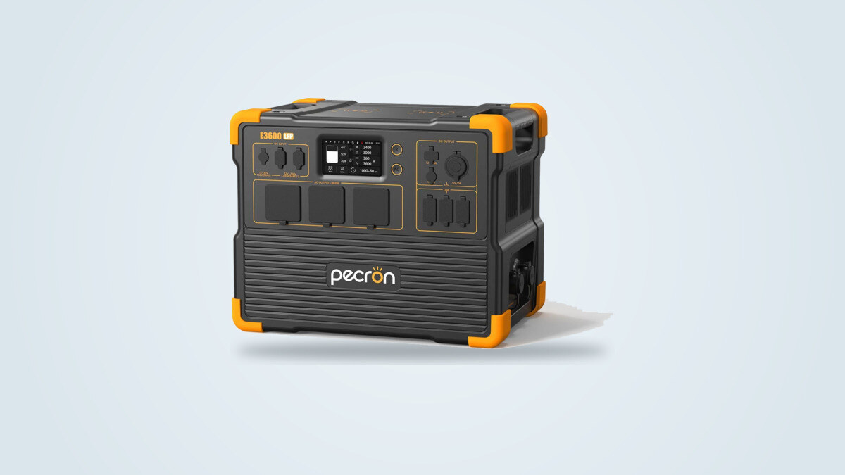 Pecron E3600LFP portable power station at a three-quarter angle, screen lit up and three European-style AC sockets visible on the front panel