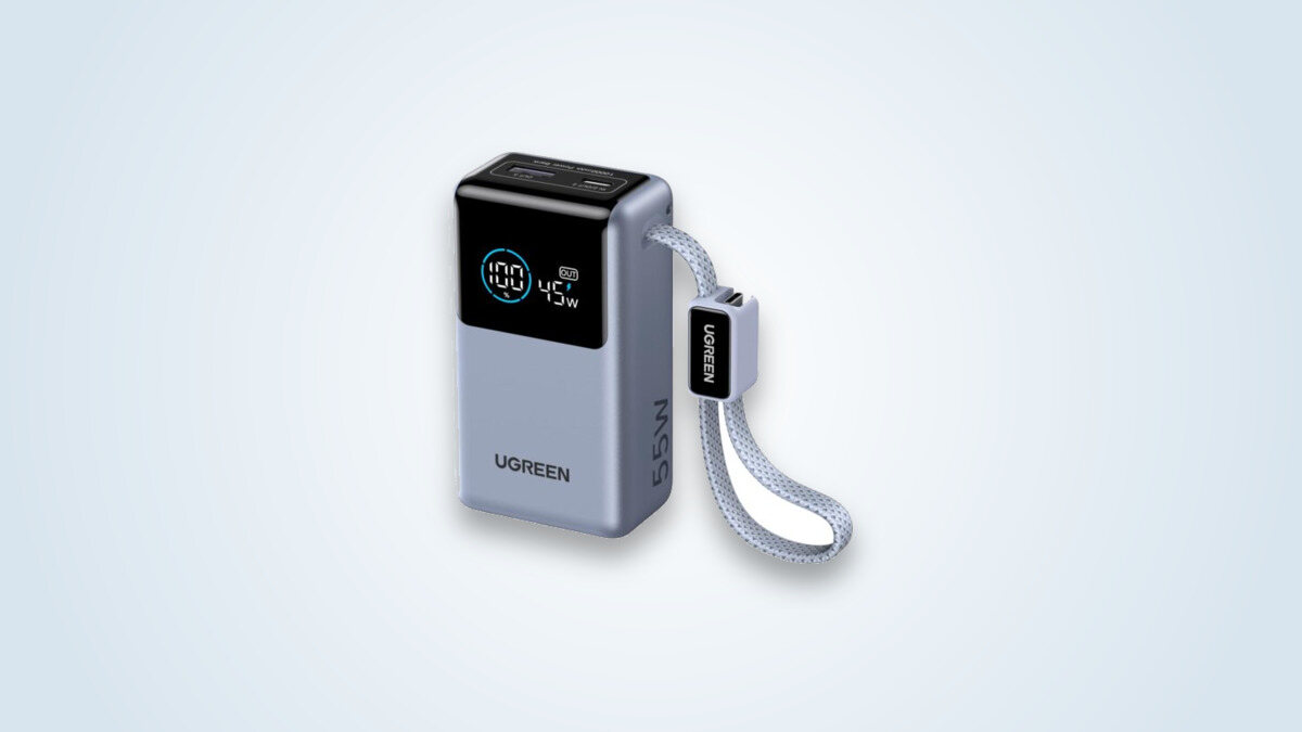 Ugreen Nexode 55W power bank, screen showing 100% charge and 45W output, integrated USB-C cable unfolded