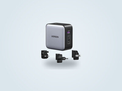 Ugreen Nexode 65W wall charger with interchangeable travel plugs on a light background