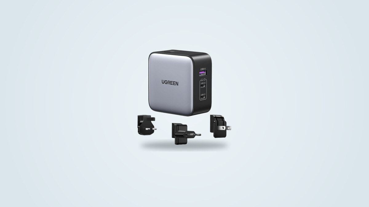 Ugreen Nexode 65W wall charger with interchangeable travel plugs on a light background