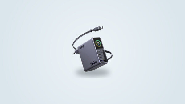Ugreen Nexode Pro 160W wall charger seen at an angle, retractable USB-C cable partly extended and screen showing power output next to the USB-C1, USB-C2 and USB-A ports