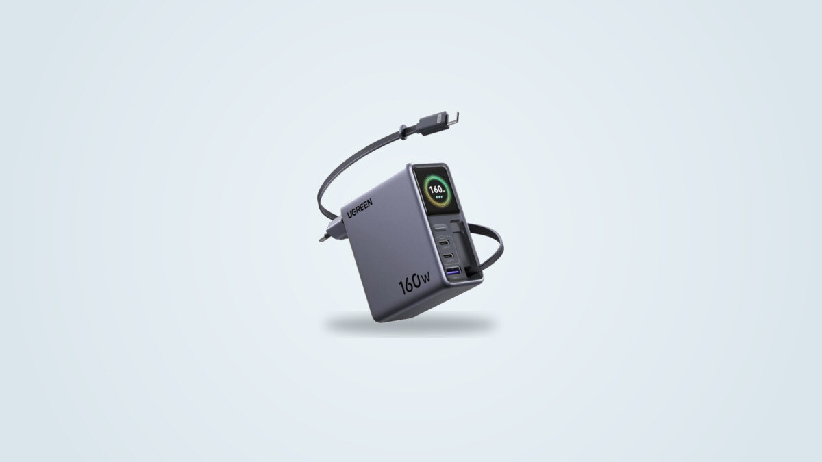 Ugreen Nexode Pro 160W wall charger seen at an angle, retractable USB-C cable partly extended and screen showing power output next to the USB-C1, USB-C2 and USB-A ports