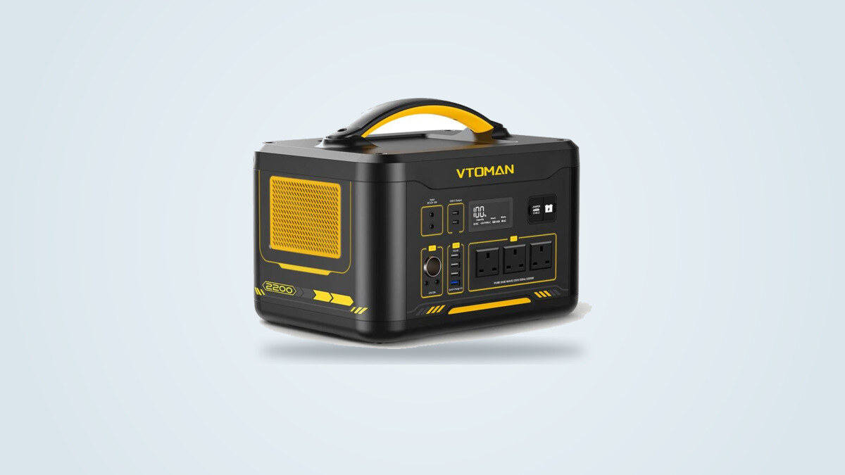 Vtoman Jump 2200 portable power station from a three-quarter angle, screen lit up, three mains sockets visible