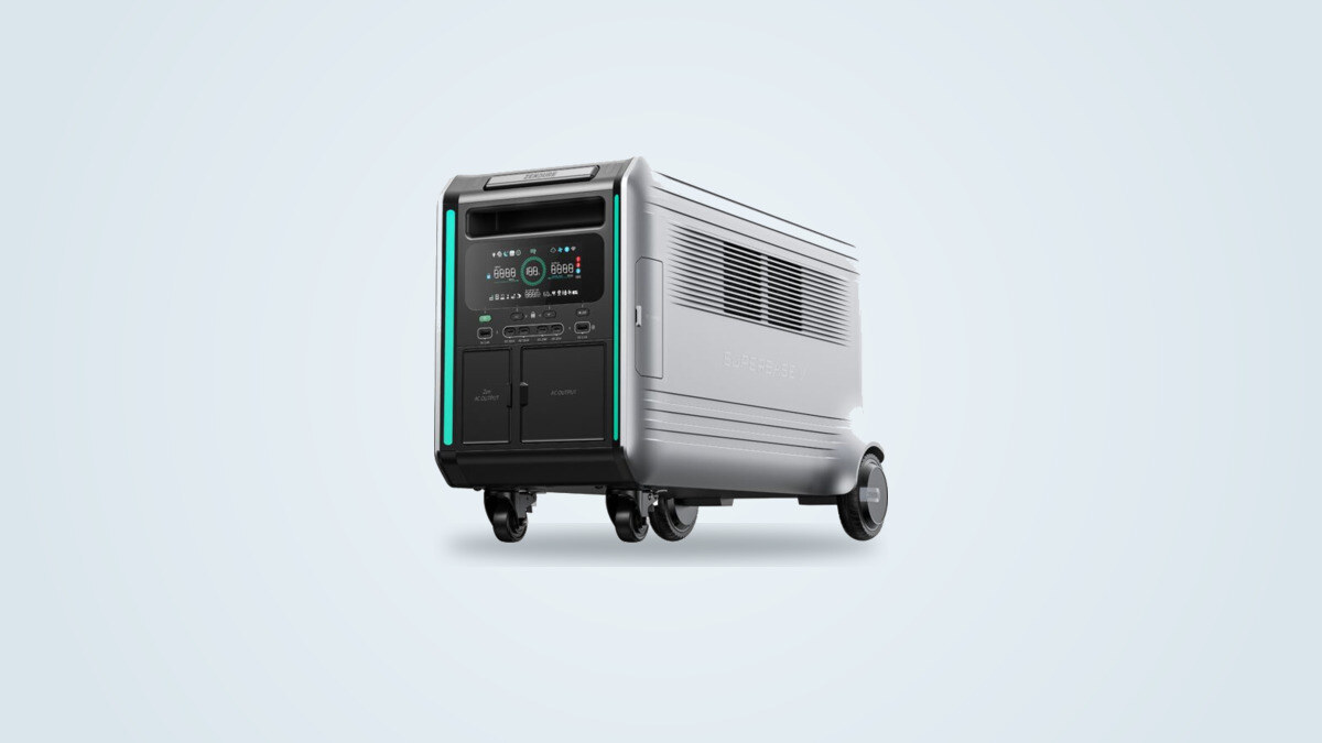 Zendure SuperBase V portable power station at a three-quarter angle, control screen lit up showing the charge level, wheels visible on the ground